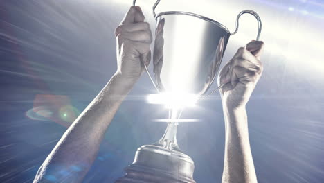 digital animation of spot of light against man holding a trophy