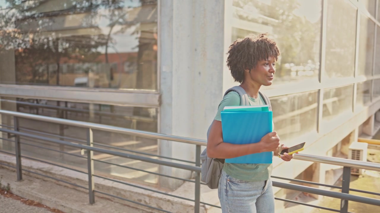 Smiling African American Woman Student Using Smartphone on Campus