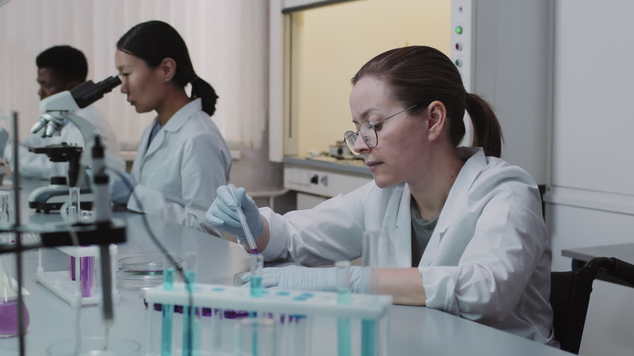 Team of Scientists Working in Lab