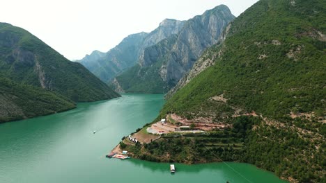 Albania,-Lake-Koman-amidst-the-Accursed-Mountains,-aerial-view-of-the-harbor