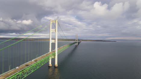 close aerial forwarding drone shot of the historic mackinac brigde connecting the upper and lower pennisula in usa