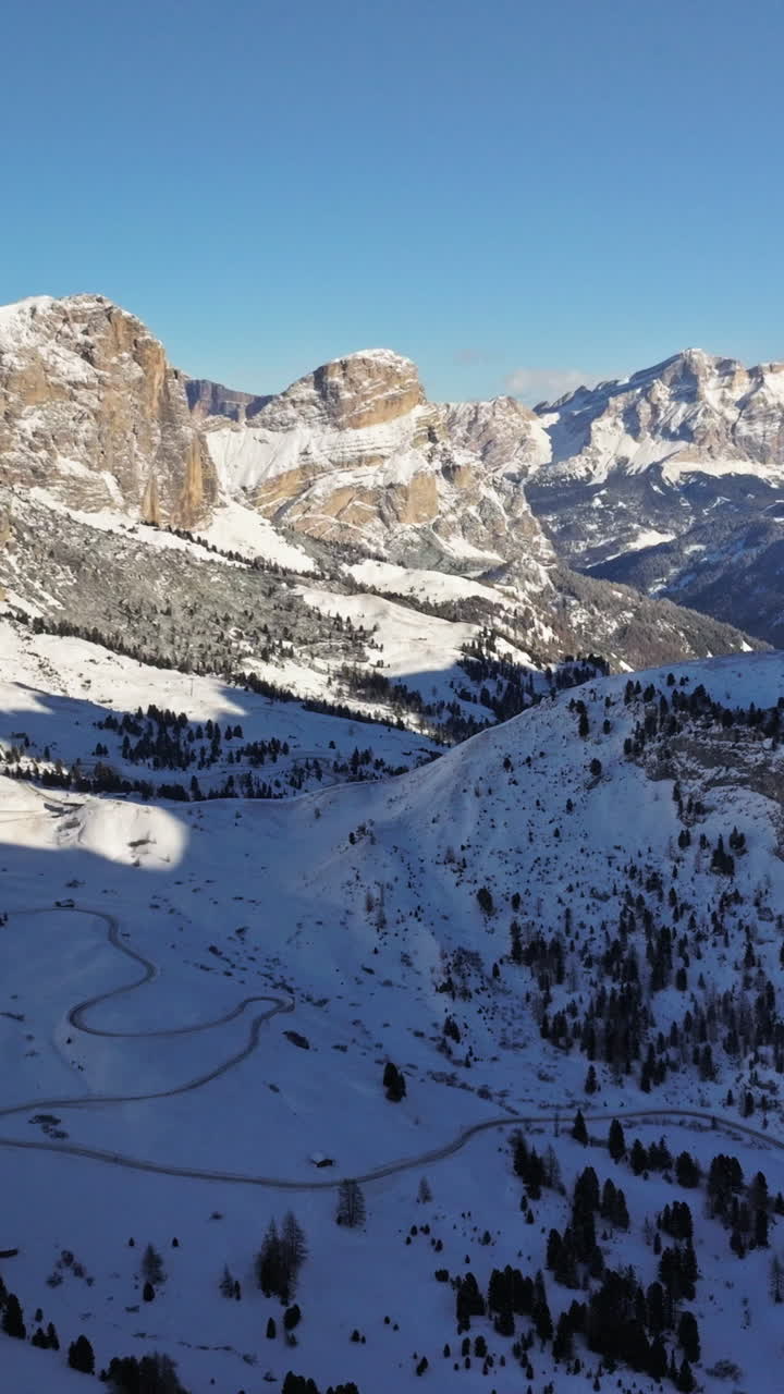 Aerial drone view of the Gardena Pass high mountain pass in the Dolomites, Italy. Vertical