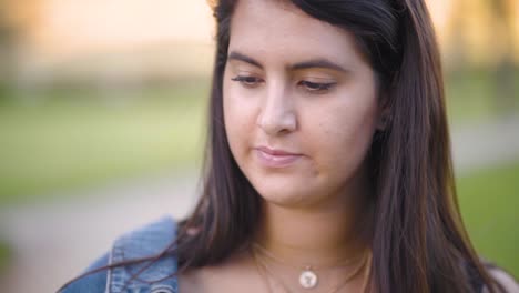 Girl-walks-in-the-park-while-thinking