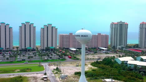 drone view of the water tower on navarre beach fl circling clockwise with views of the gulf of mexico and also the bay