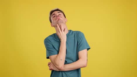 Man expressing boredom and thoughtfulness on yellow background