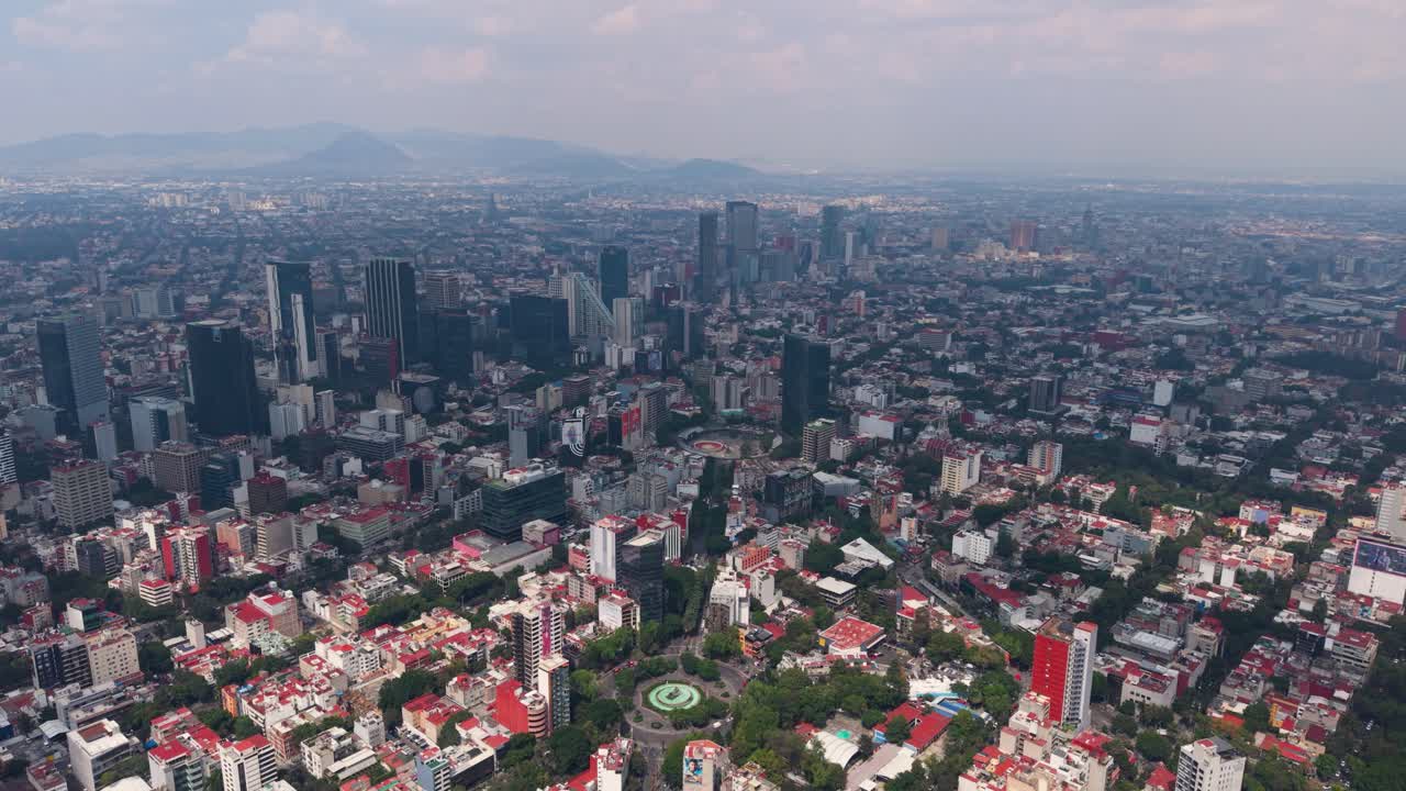 Aerial perspective of metropolis with alternating sun and clouds, Mexico City