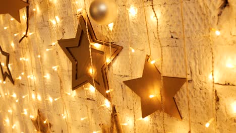 christmas garland with golden lights, close-up. blinking christmas stars lights twinkling. winter holidays concept
