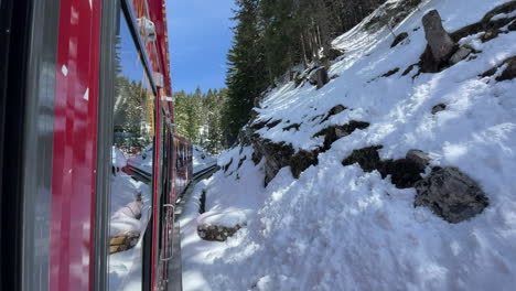 View-of-cliffs-and-mountains-out-of-red-cable-railway-or-touristic-train-on-trip-to-mountain-Schafsberg-in-Austria