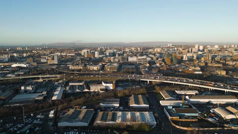 aerial static, glasgow city centre in background, during golden hour
