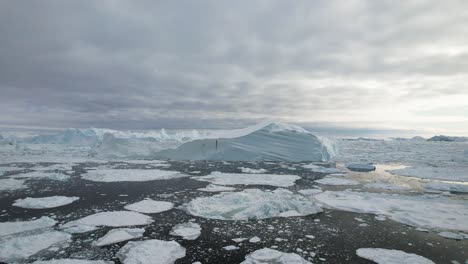 cinematic aerial view of icebergs and glacier in greenland