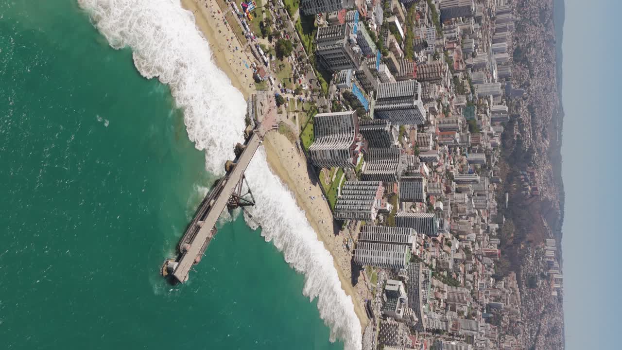 Aerial View Over Vergara Pier In Vina Del Mar With Hotel And Beach Coastline In Background