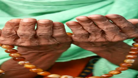 woman praying with prayer beads