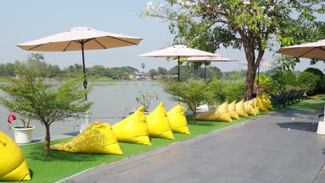 bean bags move across a scenic lakeside setting.