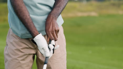 african american man hitting golf ball on the golf course.