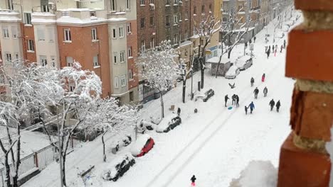 heavily snowed street of madrid viewed from a window