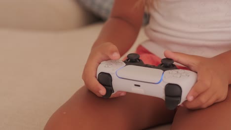 child playing video game with playstation 5 controller