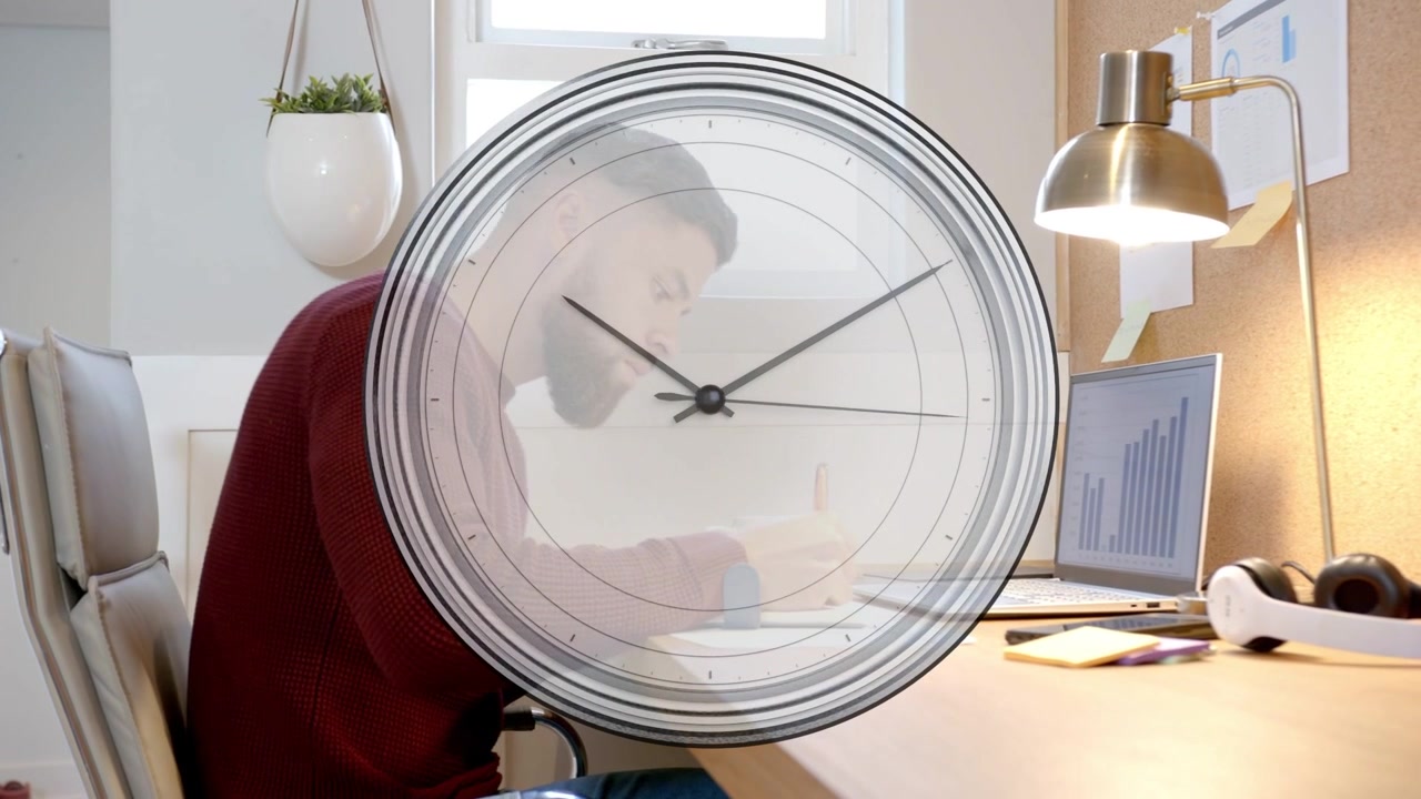 Man at desk tapping tablet, writing and sipping while analog clock overlay tracking business chart