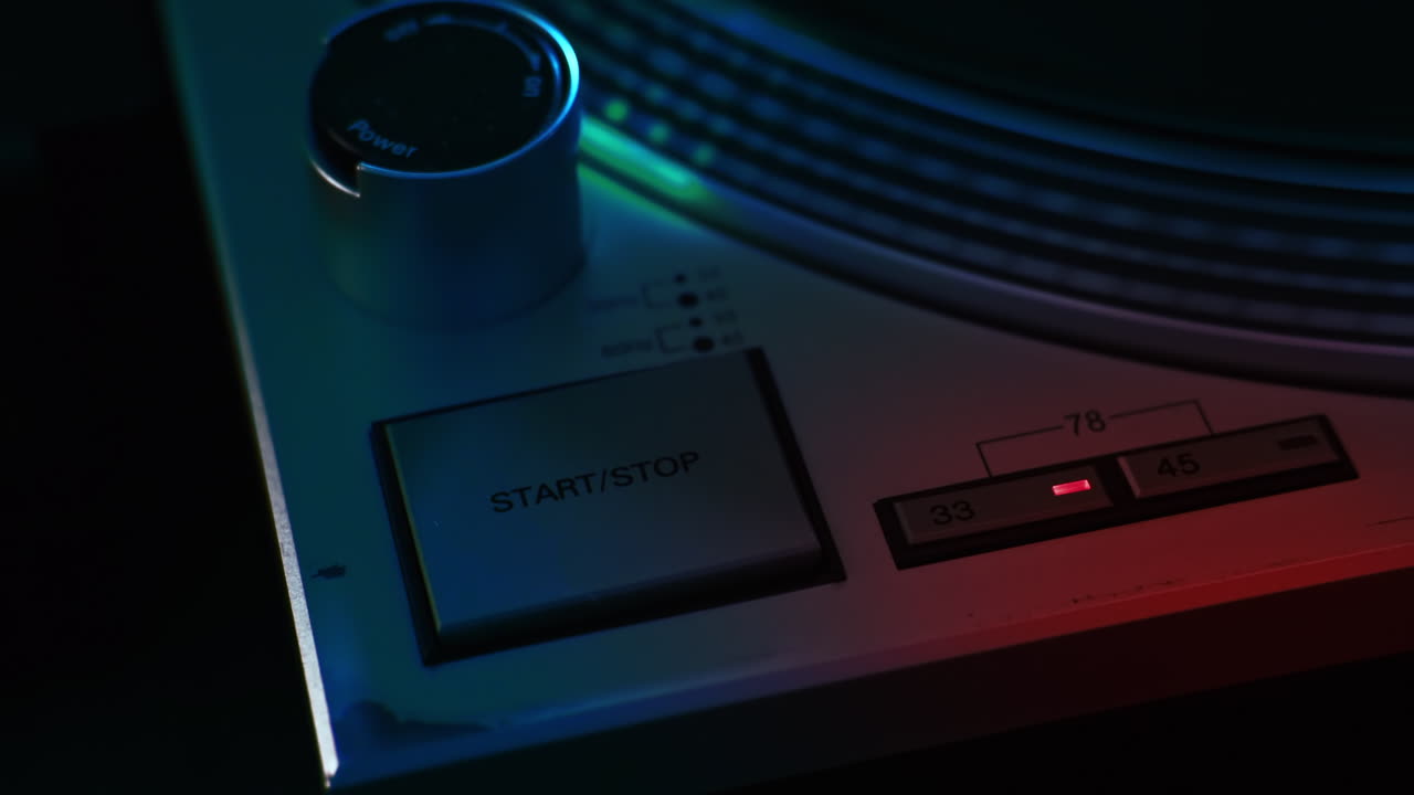 A working record player. Start and stop button. Neon red illumination around