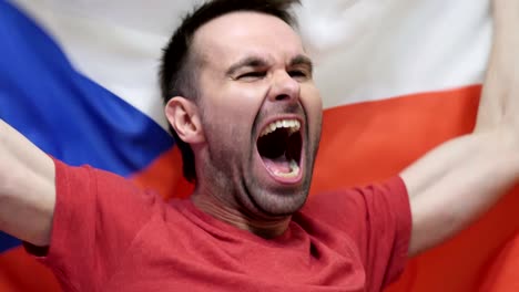 czech fan celebrating while holding the flag of czech republic in slow motion ,4k , high quality