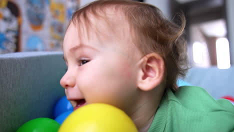 baby playing in a ball pit