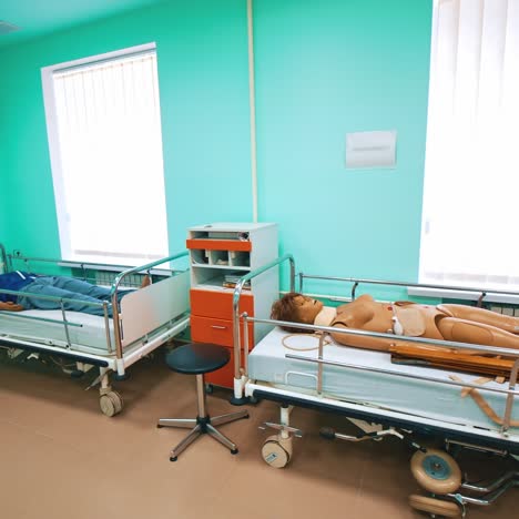 plastic dummy on hospital bed. mannequin fake patient in simulation centre for health care professionals practice