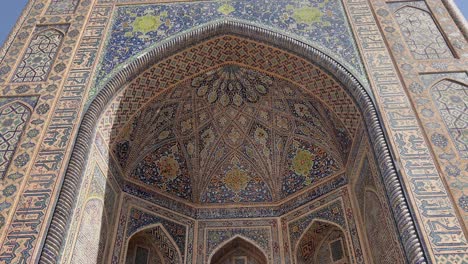 4k orbiting shot of tilla-kari madrasa's opulent mosaic portal in registan square, samarkand