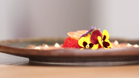 food plating - pancy flowers put on the sashimi salmon rose with red caviars as garnished