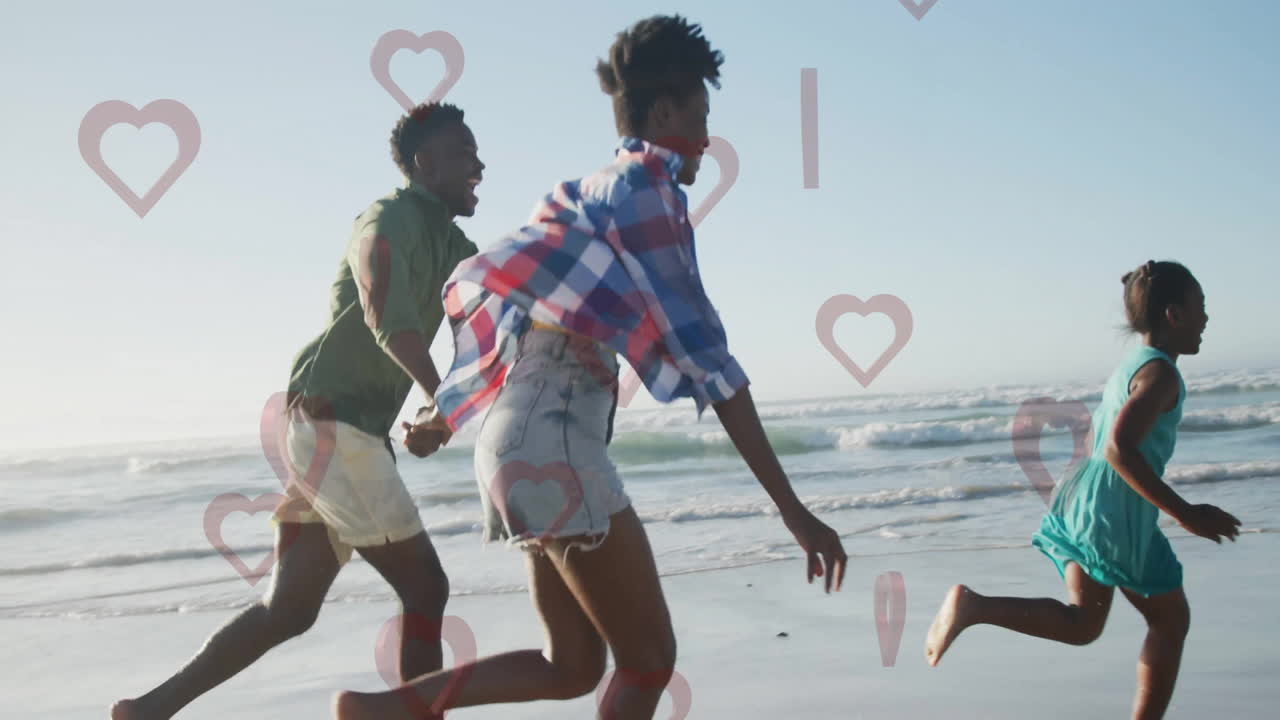 Running on beach, family with heart animation overlaying joyful scene