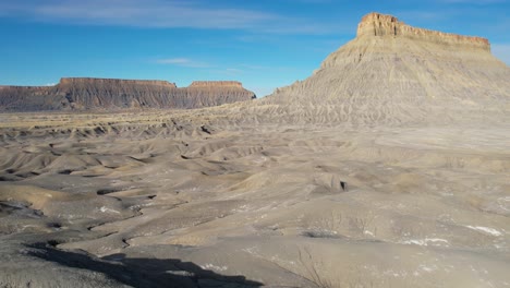 Aerial-View-of-Dry-Barren-Lifeless-Gray-Badlands-Landscape-on-Hot-Sunny-Day