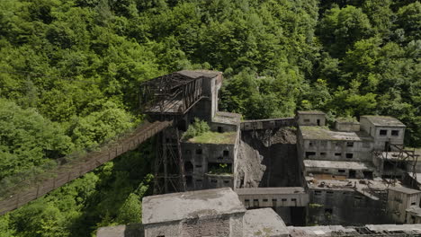 rusty freight cableway platform and ruined factory buildings, georgia