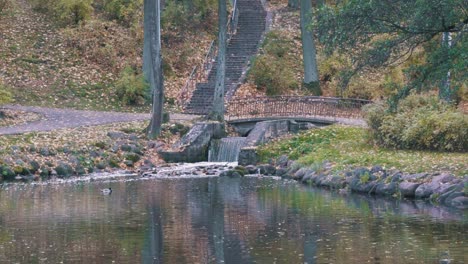 city park arkadijas with bridge and waterfall in riga, latvia, district agenskalsns