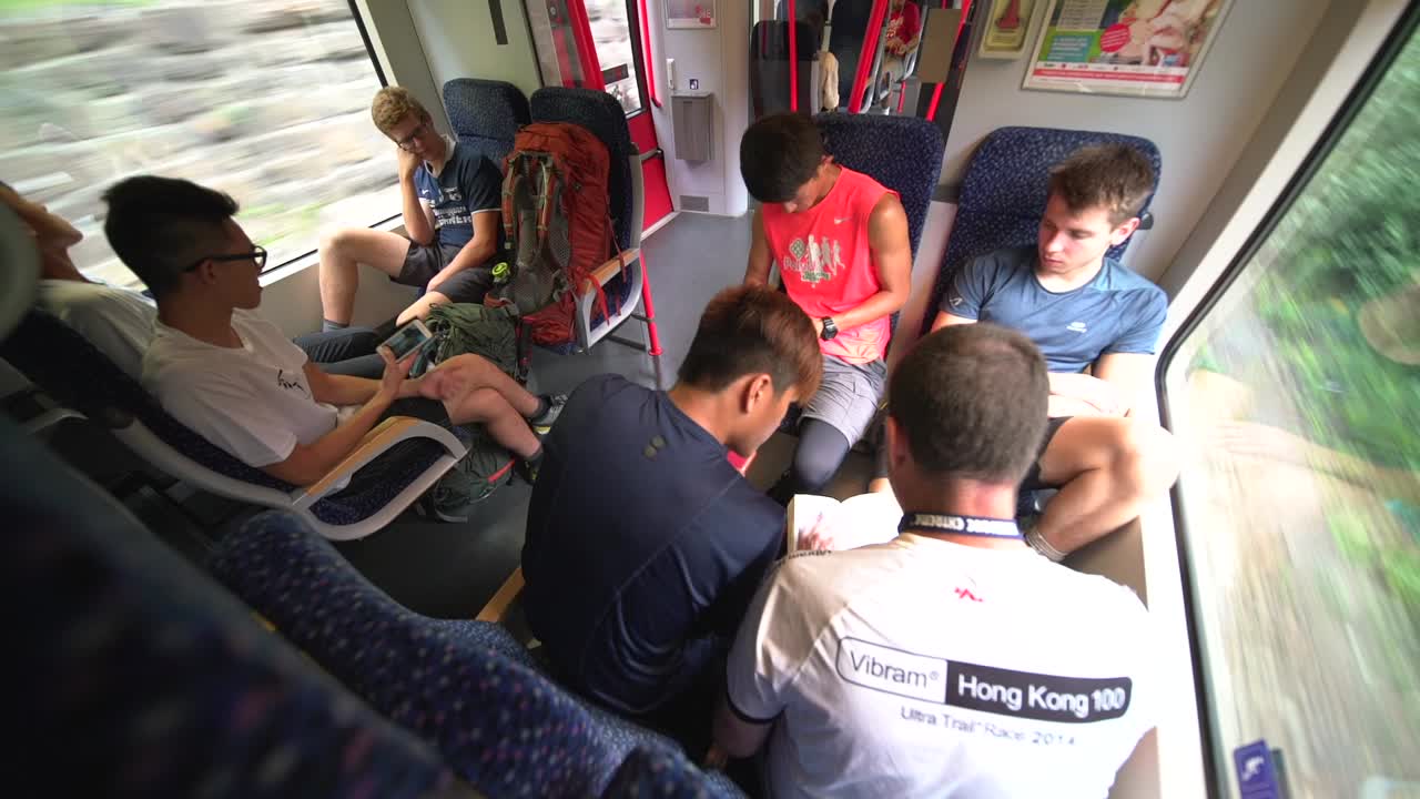 Overhead View Of A Group Of Hikers On The Train - Wide Shot