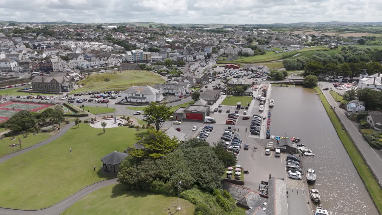 Aerial view of a coastal town with a river, harbor, and park