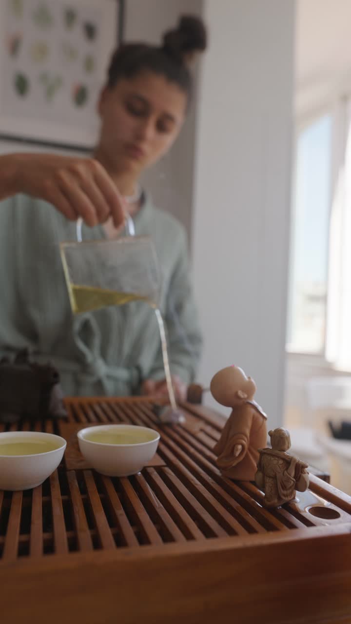 Woman pouring tea into cups