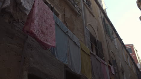 Colorful-clothes-hanging-in-window,-Venice,-Italy