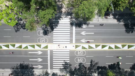 cenital drone shot of cyclists exercising in paseo de la reforma avenue in mexico