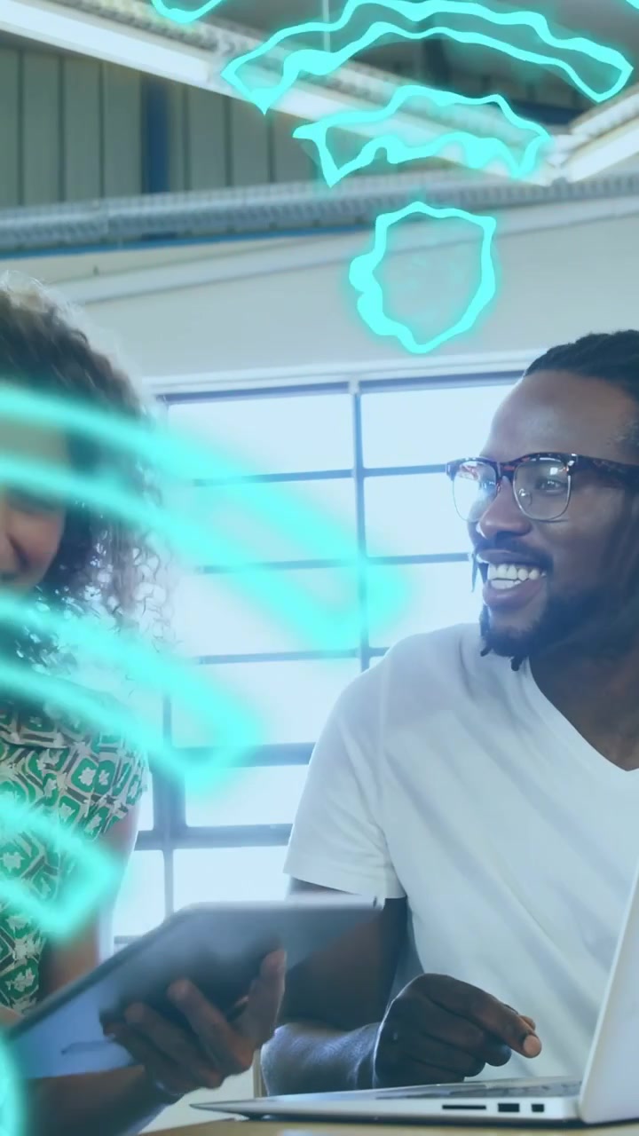 Vertical video: Woman and man examining tablet in tech demo, denim arm reaching, AR icons pulsing