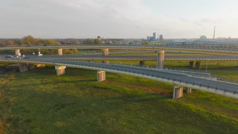 a country highway with a bridge and overpasses on which cars and trucks travel