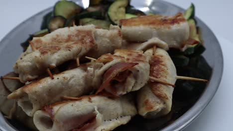 chicken rolls with zucchini in a silver tray