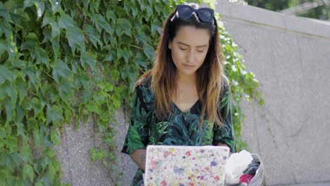 young woman talking on a mobile as she works