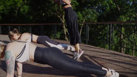 women doing push-ups outdoors