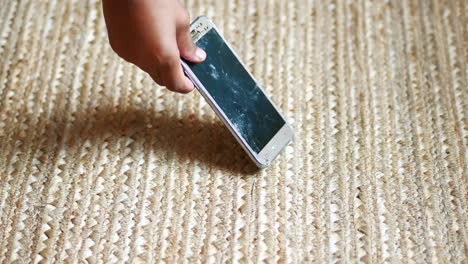 broken smartphone on a woven rug