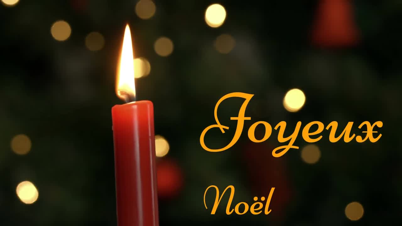 Joyeux No&Atilde;&laquo;l written over lit candle