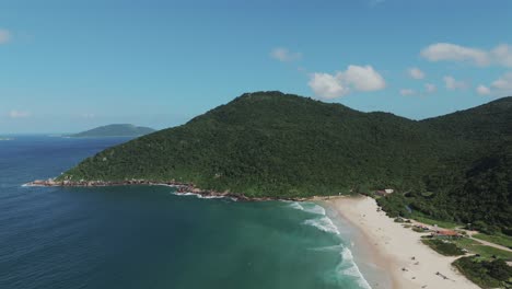 aerial view captures the magnificent brazilian coastline, with crystal-clear green waters and lush mountains adorned with dense jungle