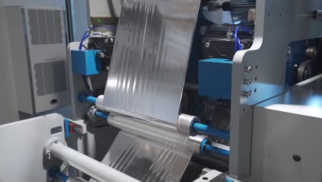 Closeup-Of-Thermoplastic-Sheet-On-Feeder-Roller-Of-Automatic-Publication-Machine