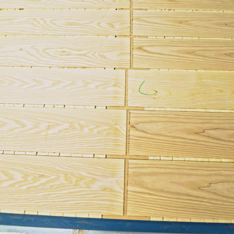 ?lean and smooth boards is going through all the processing steps for getting the final result of parquet for sale on the market. close-up.
