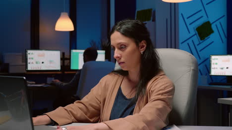 portrait of tired workaholic entrepreneur analyzing financial statistics