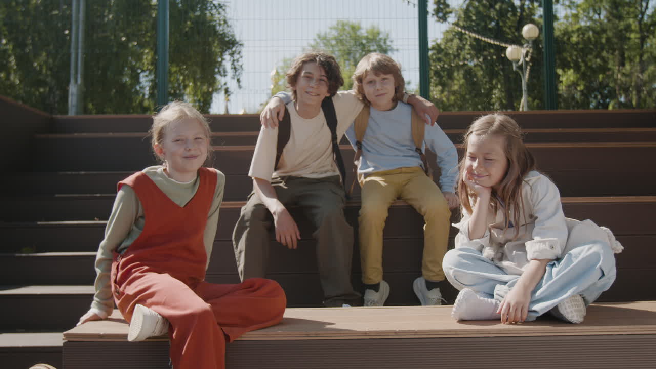 Happy Group of Children Sitting Together Outdoors