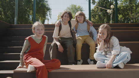 happy group of children sitting together outdoors
