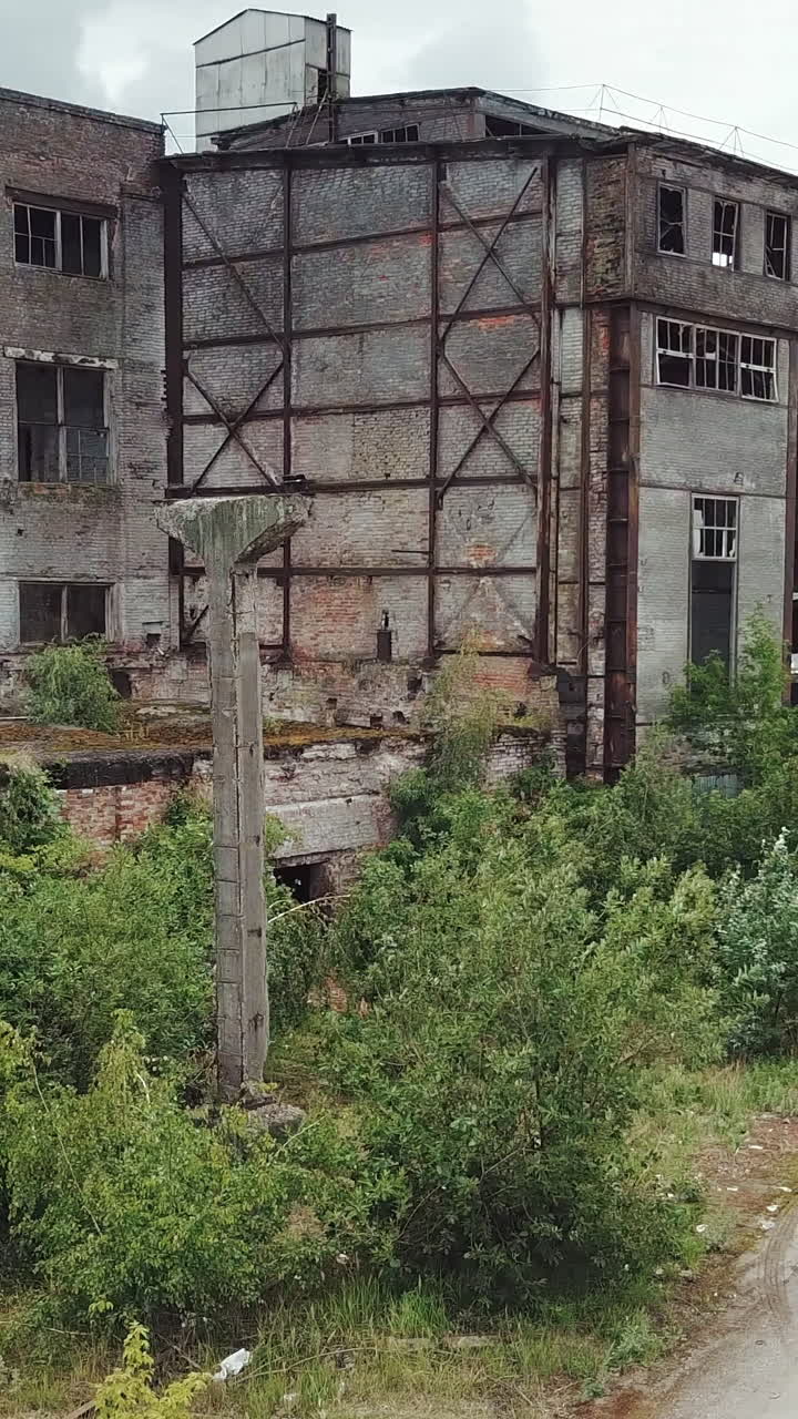 Abandoned industrial building. Aerial view.. Vertical video